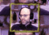 a man wearing headphones and glasses is framed in a picture frame