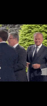 a man in a suit and tie is talking to another man in a suit and tie .