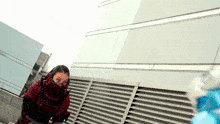 a woman in a samurai costume is standing on a rooftop