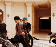 a group of young men are dancing in a room