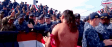 a naked woman is surrounded by a group of soldiers
