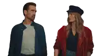 a man and woman standing next to each other on a white background