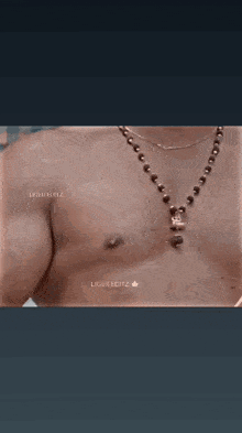 a shirtless man in a towel is holding a pan in his hands
