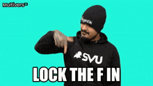 a man with a beard wearing a black hoodie and a beanie says lock the f in