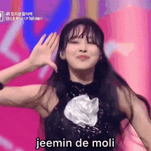 a girl giving a high five with the words jeemin de moli in the corner