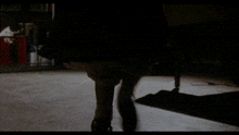 a blurred image of a dark room with a chair in the middle