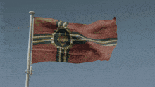 a red flag with gold stripes and a circle in the middle