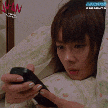 an ad for arrow presents shows a woman laying in bed looking at a cell phone