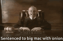 a judge sitting at a desk with the words sentenced to big mac with onion written below him