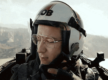 a man wearing glasses and a helmet that says ob