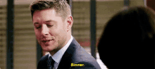 a man in a suit and tie is talking to a woman and says `` sinner '' .