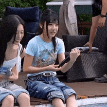 a girl wearing a blue shirt that says hello