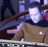 a man is playing a mood keyboard in a blurry photo
