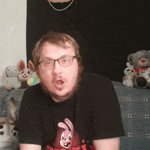 a man wearing glasses and a t-shirt with a bunny on it