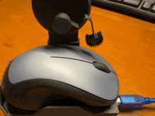 a computer mouse is plugged into a usb port on a desk