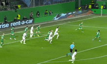a soccer field with an enterprise rent-a-car advertisement