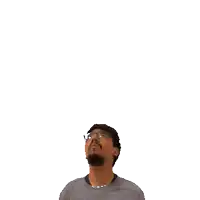 a man wearing glasses looks up at the number twelve