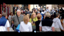 a blurred image of a crowd of people with the hashtag /haarikaandflossine
