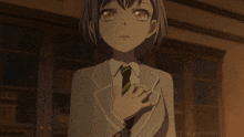 a girl in a suit and tie with her hands folded in front of her chest