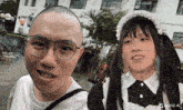 a man with glasses and a woman in a maid outfit
