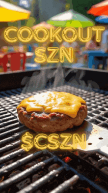a hamburger is cooking on a grill with the words cookout szn below it