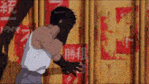 a man is covering his face with his hands while standing in front of a wall with chinese writing on it