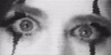 a black and white photo of a woman 's eyes looking at the camera .