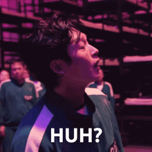a man in a green shirt says huh in white letters