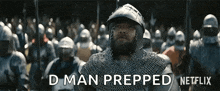 a man in chain mail is standing in front of a crowd of soldiers and says " d man prepped " .