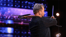 Shooting Blindly Americas Got Talent GIF - Shooting Blindly Americas Got Talent Agt GIFs