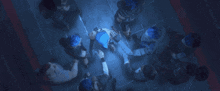 a group of people are gathered in a dark room looking up