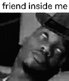 a black and white photo of a man in a hat with the words `` friend inside me '' written on it .