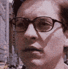 a close up of a person 's face with glasses