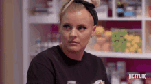 a woman wearing a black t-shirt that says netflix