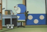 a cartoon of doraemon sitting in a chair in a room