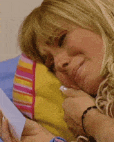 a close up of a woman laying on a bed