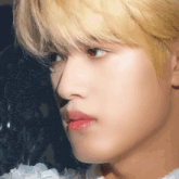 a close up of a man 's face with blonde hair and red lips