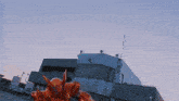 a large fireball is erupting from a building