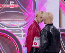 two men are standing next to each other and one has a sticker on his chest that says ' a ' on it