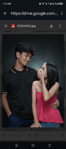a phone screen shows a picture of a man and woman laughing