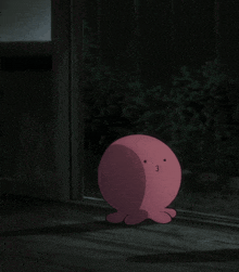 a pink cartoon character is sitting on the ground in the dark