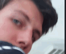 a close up of a man 's face with a blurry background