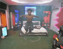 a man is jumping in the air in a bedroom with a soccer field on the floor