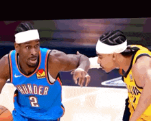 a man in a thunder jersey is talking to another man