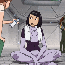 a woman in a purple suit with the number 1 on her chest sits on the floor