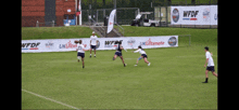 a group of people are playing a game of ultimate frisbee on a field