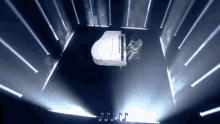 a man playing a piano in a dark room