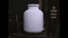 a large white container with a label on it is sitting on a table .