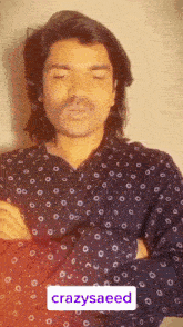 a man with a mustache is wearing a shirt that says crazysaeed on the front