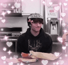 a man wearing a tiara is in front of a refrigerator that says subscribe on it
